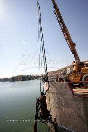 Image du Maroc Professionnelle de  Un ouvrier s'active sur un engin servant au  nettoyage du Barrage Machraa Hamadi dont la capacité est de 42 Millions de m3, est construit sur l'Oued Moulouya, il permet, depuis 1956, d'approvisionner la région et d'irriguer les terres de cultures, ce barrage fournit en eau potable les ville de Nador, Oujda, il permet également l'approvisionnement des centre de Taourirte et El Aïoun Sidi Mellouk. Samedi 1er octobre 2005. (Photo / Abdeljalil Bounhar)